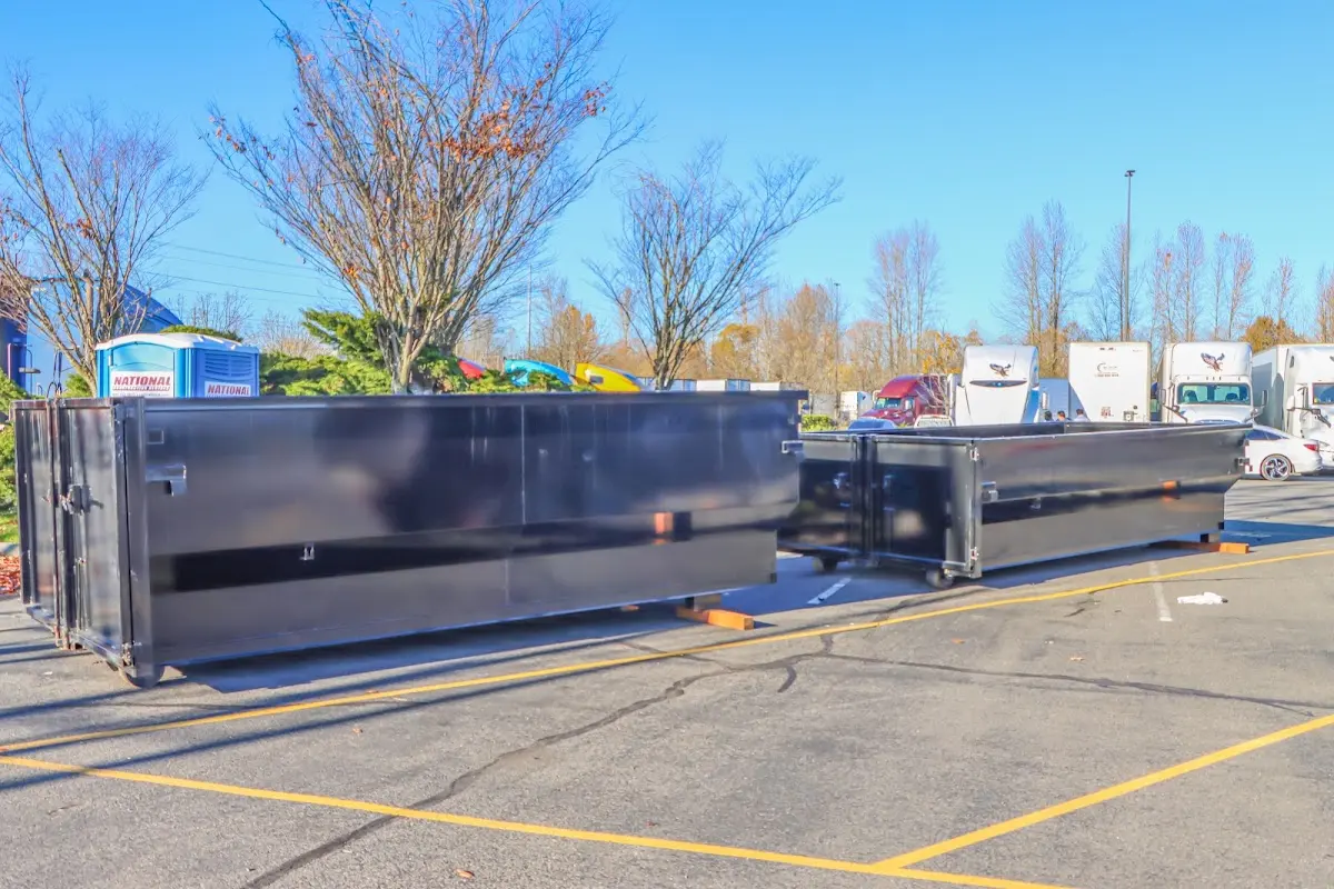 Professional dumpster rental service with roll-off container on residential driveway in Urbandale